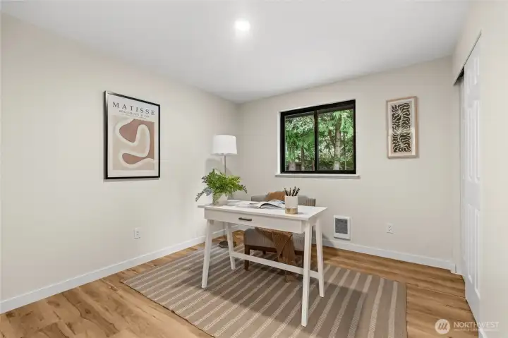 The ultimate work-from-home setup. This quiet secondary bedroom has been reimagined as a bright, dedicated office, offering the privacy you need for deep focus and productivity.