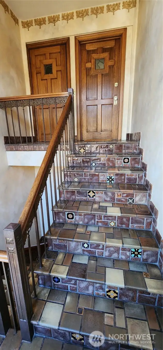 Beautifully tiled staircase to entry door