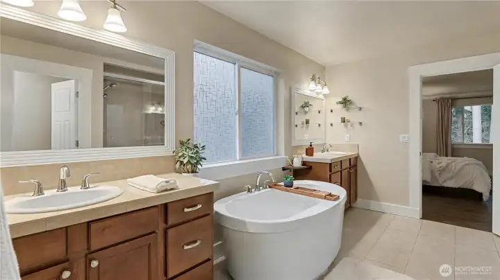 The expansive primary ensuite offers a soaking tub, dual vanities, and a bright, open feel.