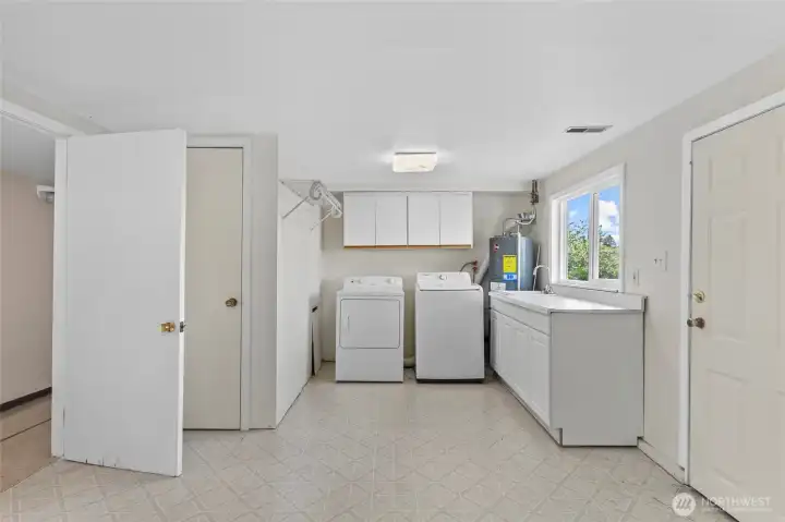 Large laundry and utility/mud room, opens to backyard