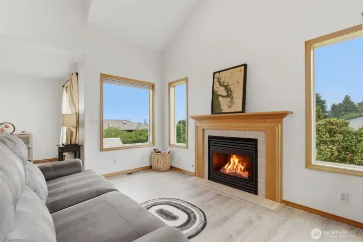 Cozy fireplace and vaulted ceilings create a warm, open living space filled with character and natural light.