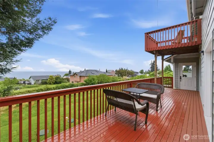Main deck offers a peaceful spot to enjoy your morning coffee, entertain friends, or simply relax while taking in the water views.