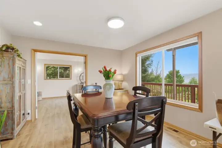 Large dining room with high ceilings and a stunning picture window that fills the space with natural light and showcases the surrounding views.