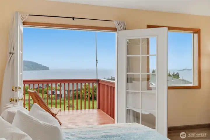 French doors open to a private deck—creating a peaceful extension of the primary bedroom and an ideal place to enjoy the views.