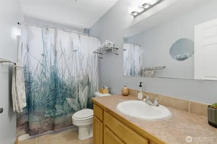 Full bathroom on the upper level offers convenience and functionality for everyday living and guests.