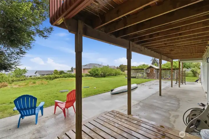 Lower-level patio area offers easy outdoor living—grab your kayak and head down the easement for convenient beach access and waterfront adventures.