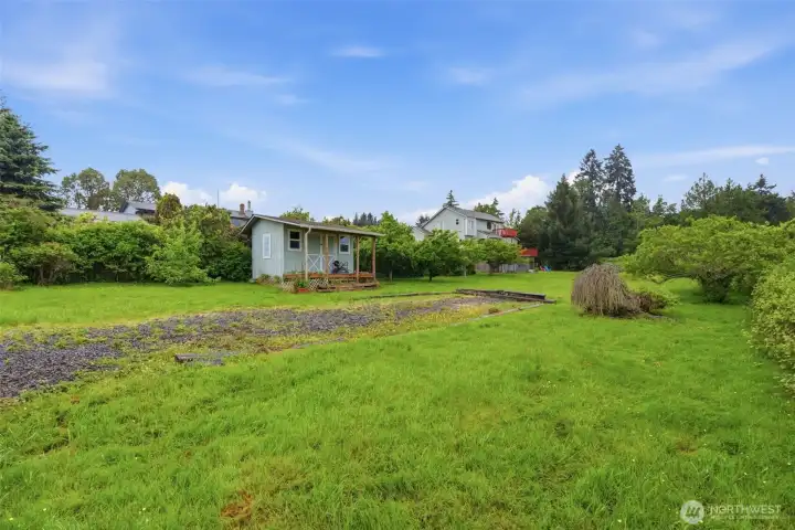 Cute garden shed and established grapevines add charm and character while beautifully framing the yard.