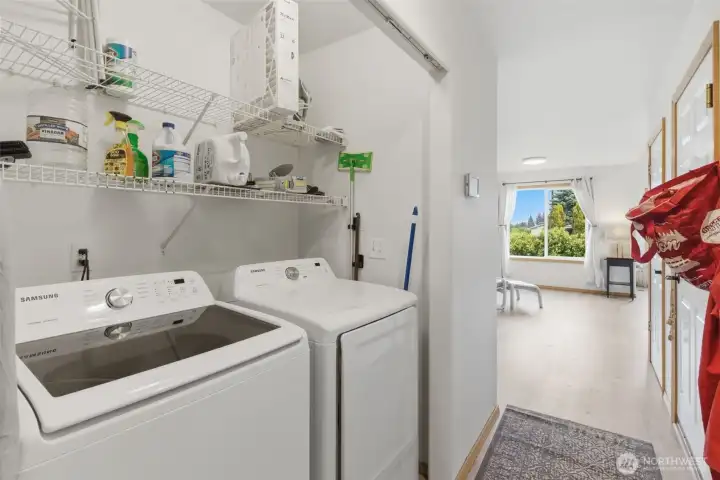 Convenient laundry area located just inside the garage entry—perfect for everyday functionality and easy clean-up after outdoor activities.