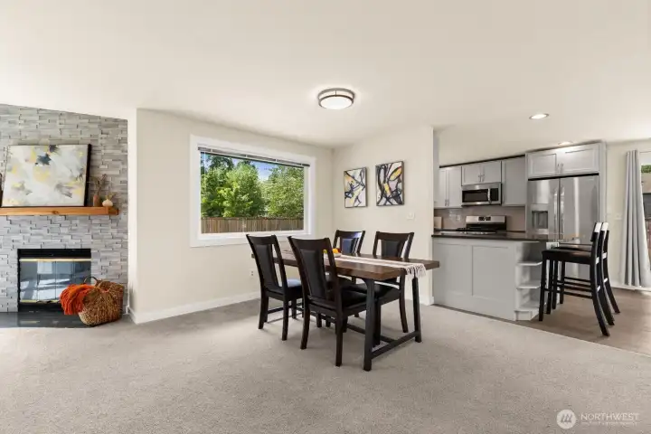 Open dining area flows seamlessly between the gas fireplace and the updated kitchen — no walls, no wasted space. Open dining area flows seamlessly between the gas fireplace and the updated kitchen — no walls, no wasted space.