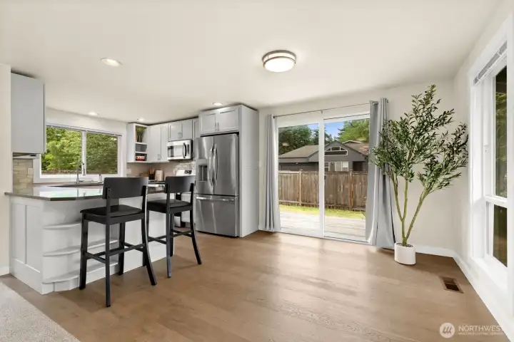 Kitchen peninsula with bar seating opens directly to the slider and deck. Great for indoor-outdoor entertaining. Kitchen peninsula with bar seating opens directly to the slider and deck. Great for indoor-outdoor entertaining.