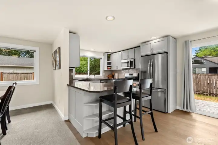 Updated kitchen with gray shaker cabinets, stainless appliances, gas range, and a peninsula that connects to the backyard deck. Updated kitchen with gray shaker cabinets, stainless appliances, gas range, and a peninsula that connects to the backyard deck.