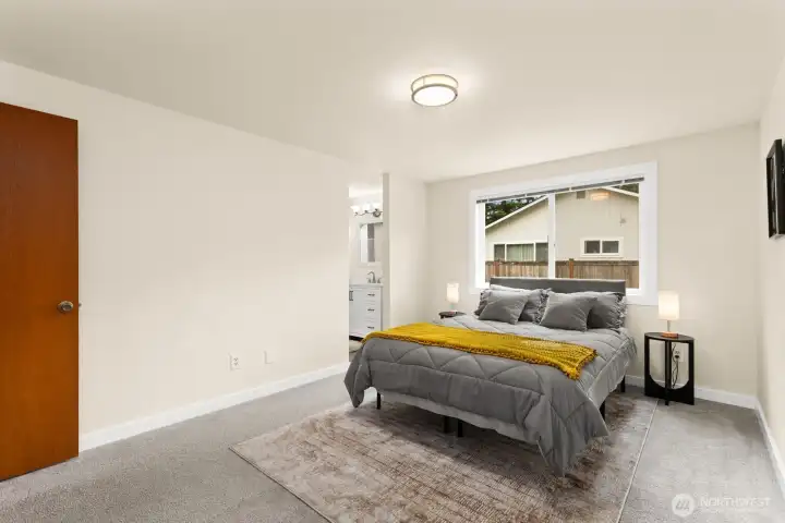 Spacious primary bedroom with en suite bath and walk-in closet just through the door. Spacious primary bedroom with en suite bath and walk-in closet just through the door.