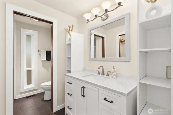 Primary bathroom with tile flooring and lots of storage. Primary bathroom with tile flooring and lots of storage.