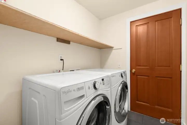 Utility room adjacent to hall and garage. Utility room adjacent to hall and garage.