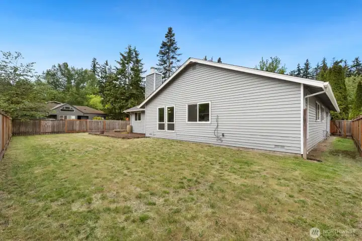 The corner lot gives this backyard more breathing room than most. Flat, fully fenced, unobstructed space. The corner lot gives this backyard more breathing room than most. Flat, fully fenced, unobstructed space.