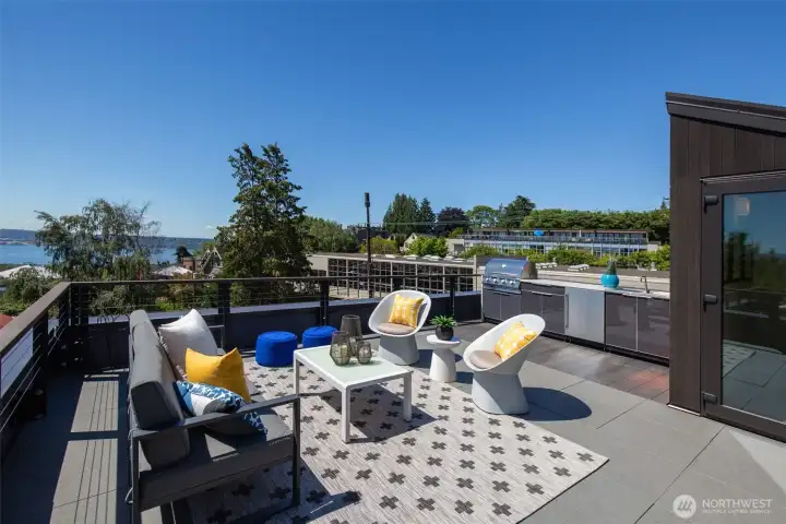 590 square feet of private rooftop space, anchored by a custom NewAge® outdoor kitchen — BBQ, refrigerator, quartz counters, custom cover. A $7,500 addition, included. Dinner with a skyline view. 590 square feet of private rooftop space, anchored by a custom NewAge® outdoor kitchen — BBQ, refrigerator, quartz counters, custom cover. A $7,500 addition, included. Dinner with a skyline view.