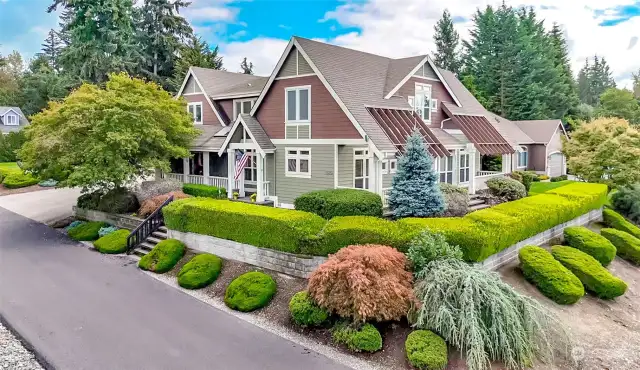 Mature landscaping to this one of a kind home in Orion Ridge.  Inground sprinkler system and lots of parking.