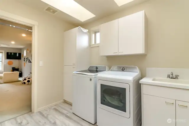 Upstairs laundryroom with built in cabinets