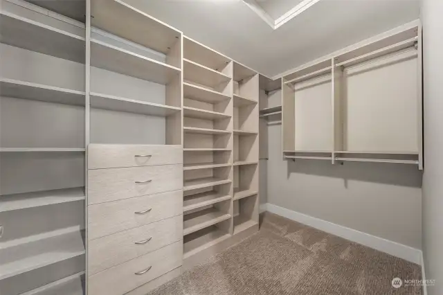 The primary closet is a dream come true with built-in organizers, hanging systems, and storage solutions that make staying organized effortless.