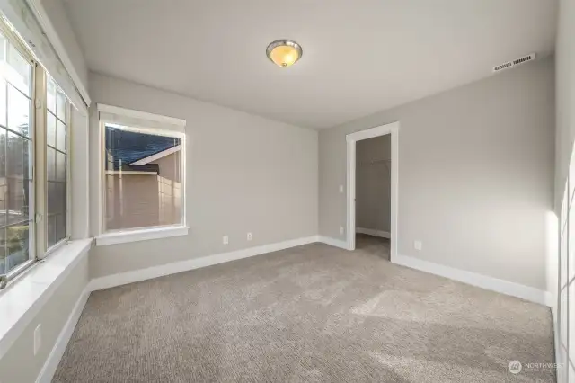 Incredible light filled bedroom #3 over looking front yard + walk in closet.