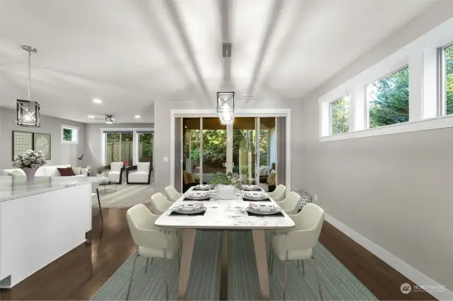 Lovely dining area just off the kitchen & family room with large sliding doors to covered back patio area & outdoor fireplace.