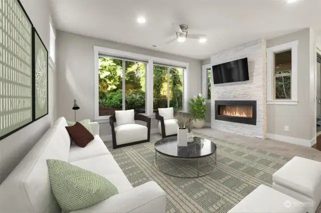 The family room features a stunning stone statement wall, double-sided fireplace that enhances the space with style and functionality, perfect for creating cherished memories with loved ones.