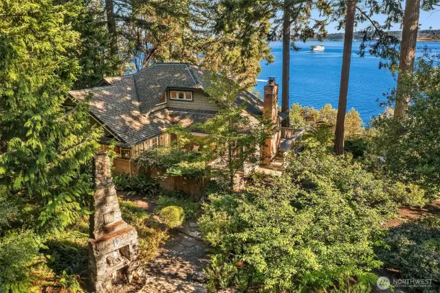 The home is nestled amongst tall trees with gorgeous southern views of Puget Sound, Mt. Rainier and Tacoma.