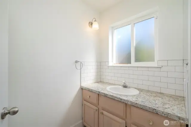 Main floor 3/4 bath, shower and toilet behind door
