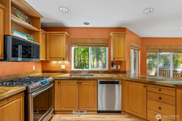 Spacious kitchen with high end countertops.
