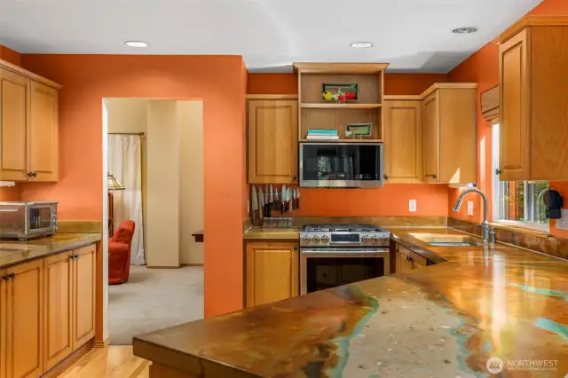 Spacious kitchen with high end countertops.