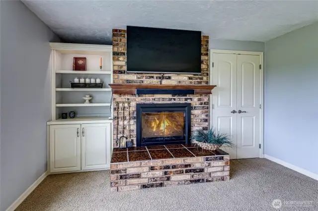 Floor to ceiling brick fireplace.