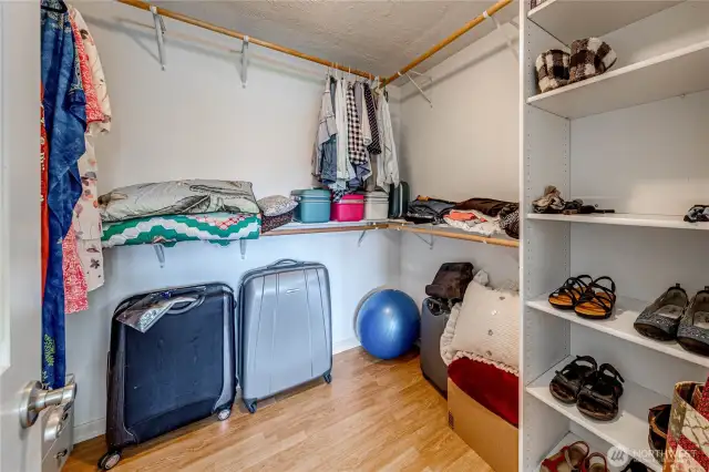 Primary walk-in closet with shelving.