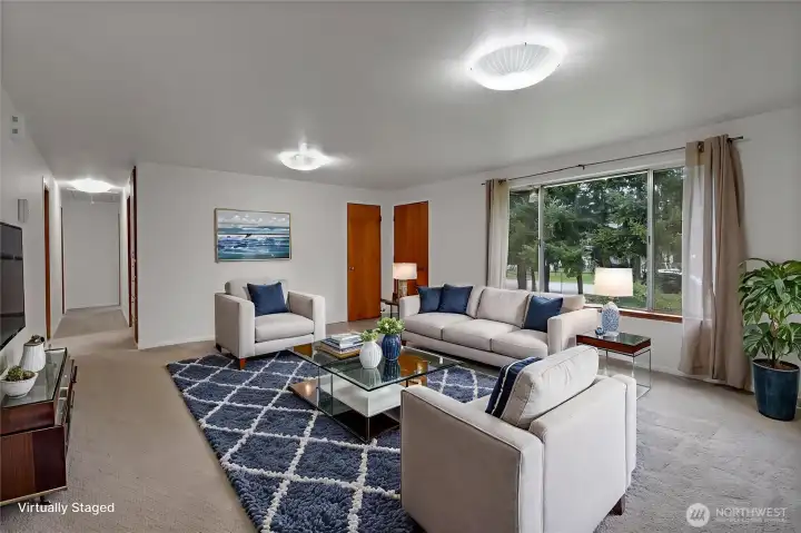 Huge living room with newer vinyl windows and wood burning stove.