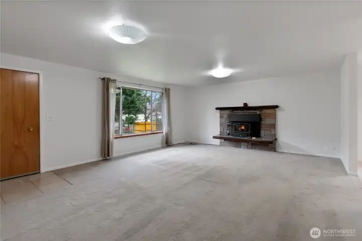 Living room with wood stove that will keep you cozy this winter.