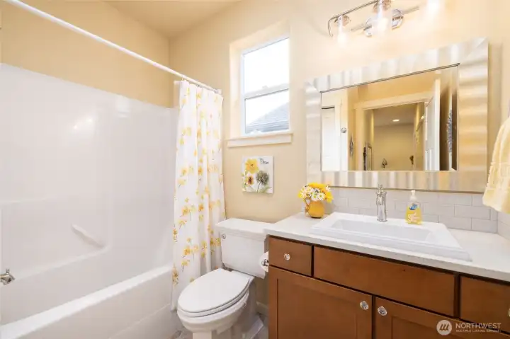 Full guest bath with quartz counters and great storage
