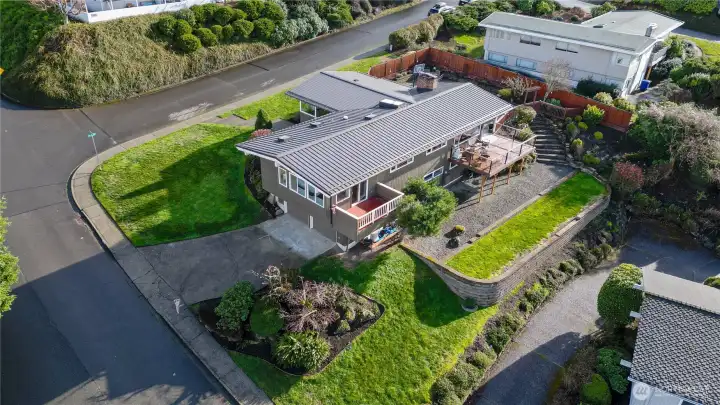 Stairs from the back patio descend to additional outdoor activity area.