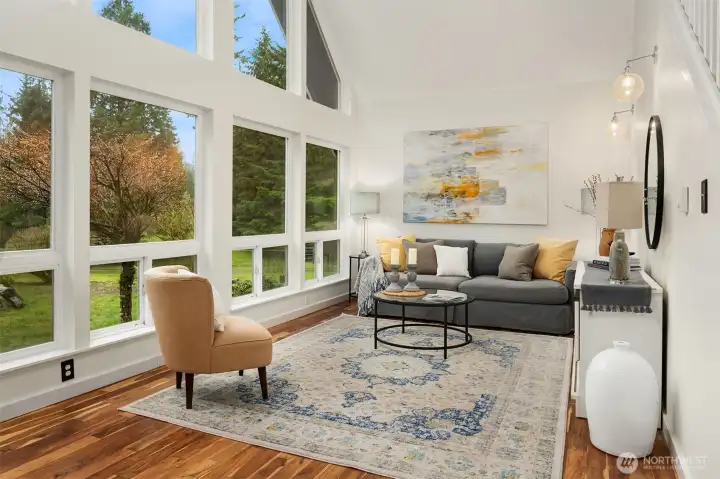 Living Room with soaring ceilings and floor-to-ceiling windows for natural light.