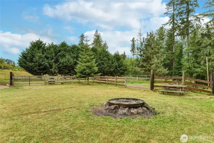 Enjoy an evening campfire! Arena gate to the left and level pasture access beyond the fire pit.