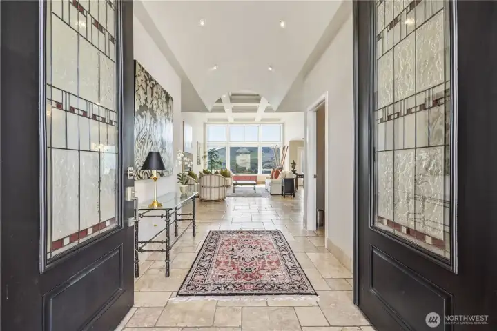 Grand entryway welcomes you with elegant double doors, soaring ceilings, and a light-filled hallway that draws your eye through to the home’s main living spaces. Refined finishes, and warm natural light create a sophisticated and inviting first impression.