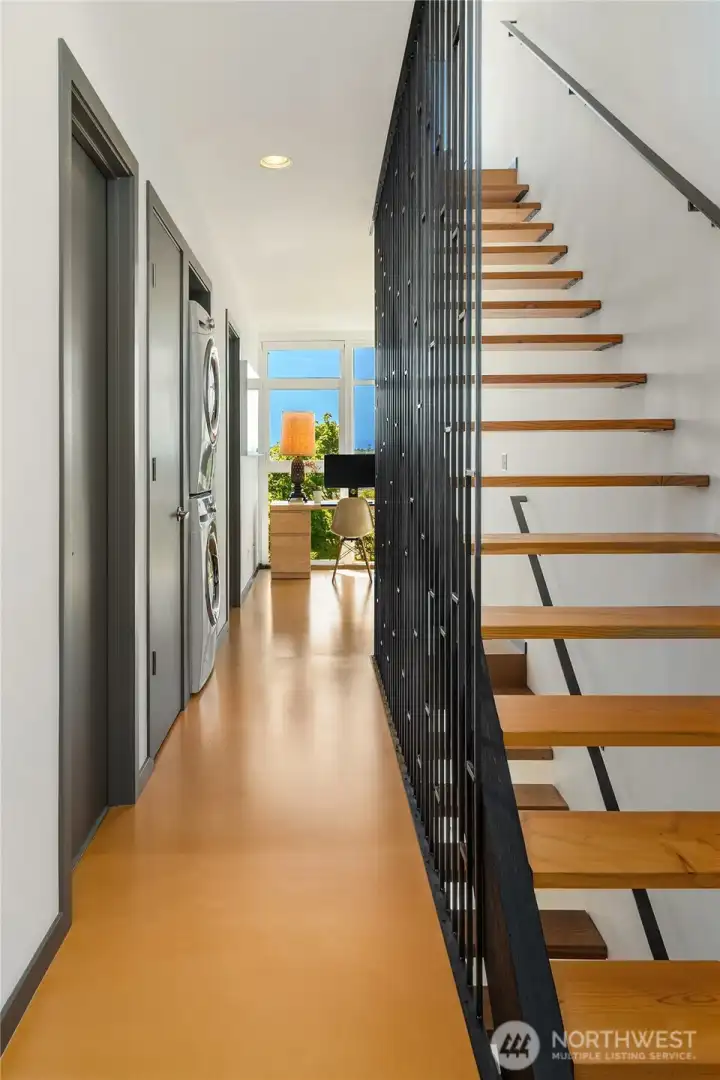 The open, reclaimed-fir stairwells feature a custom steel slatwall