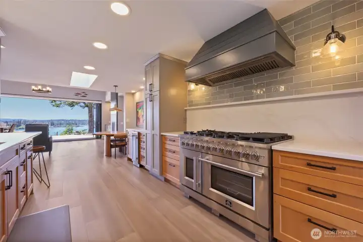 Chef's gas range with double oven and custom hood. Chef's gas range with double oven and custom hood.