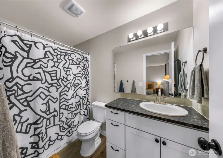 Primary Bathroom, newer vanity, lights, paint, flooring and granite countertop!