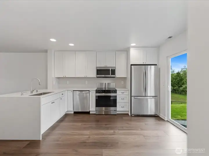 Beautifully renovated kitchen showcasing custom full-height wood cabinetry, quartz countertops with waterfall edge, and new stainless steel appliances including a Smart oven with air fry and convection settings. No expense was spared in creating a luxurious yet functional space designed for everyday living and entertaining. Beautifully renovated kitchen showcasing custom full-height wood cabinetry, quartz countertops with waterfall edge, and new stainless steel appliances including a Smart oven with air fry and convection settings. No expense was spared in creating a luxurious yet functional space designed for everyday living and entertaining.
