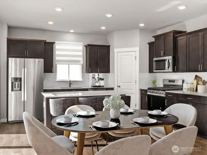Your kitchen provides a gas cooktop, slab quartz countertops, full height backsplash and plenty of counter space.  Photos are for representational purposes only. Colors and options may vary.