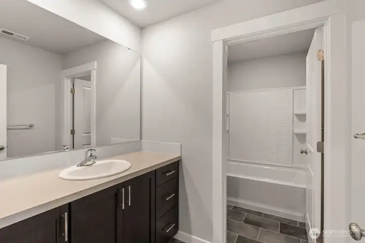 Hall bath with separate tub/shower area. Photos are for representational purposes only. Colors and options may vary.