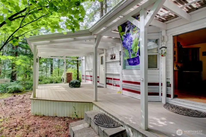 Park model trailer with a large covered deck