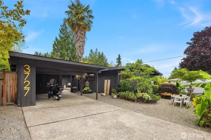 Grab your sunglasses & savor that 1950s Palm Springs vibe, complete with a carport & curated tropical trees.