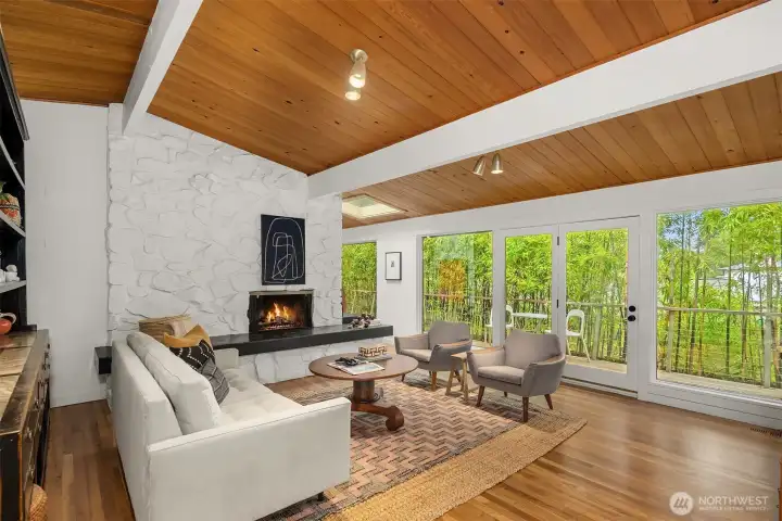 Iconic vaulted ceilings with timber beams are anchored by refinished hardwood floors.