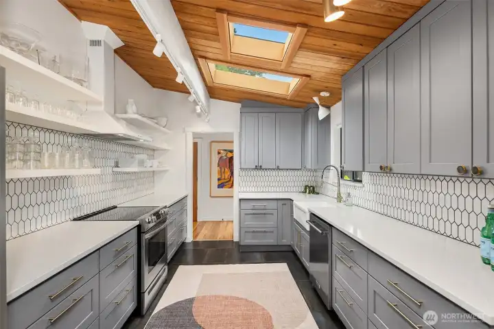 Newly updated, sky-lit kitchen with stainless steel appliances.