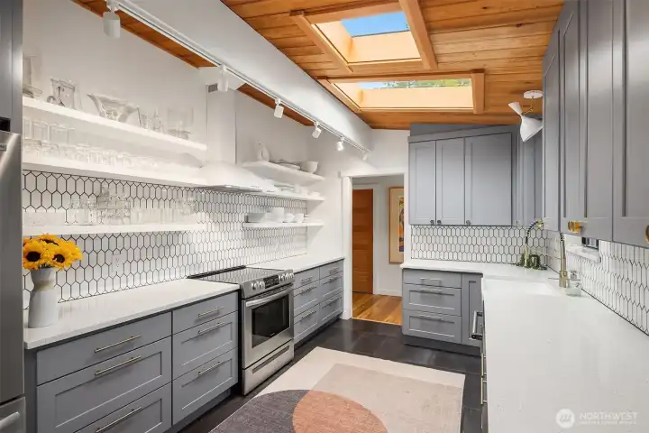 Sleek open shelving & shaker style cabinets add a modern yet timeless feel.